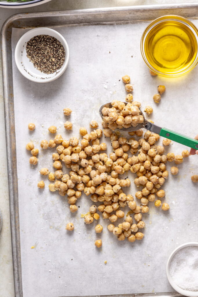 chickpeas tossed in salt, pepper, and cornstarch on a sheet pan