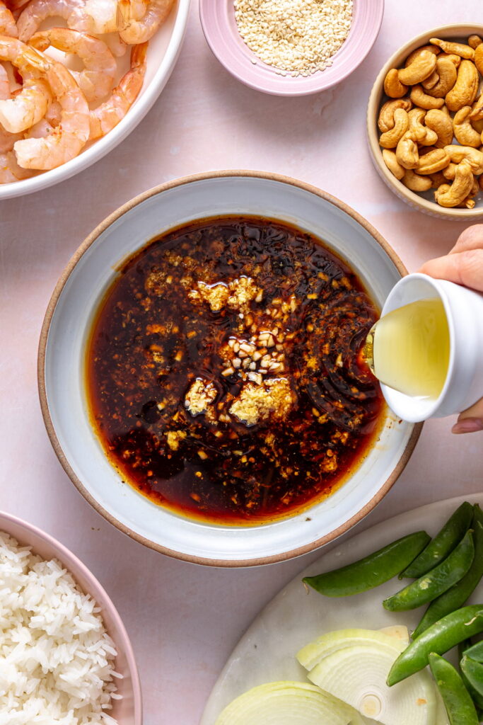 making a shrimp stir fry sauce in a bowl
