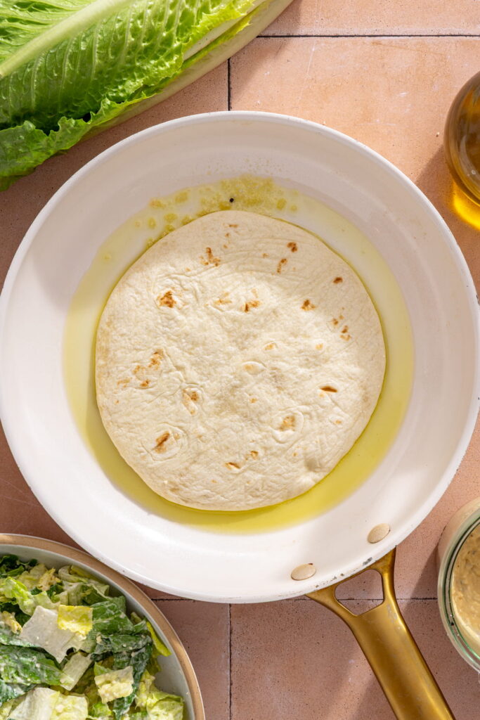 frying chicken smash tacos in a pan