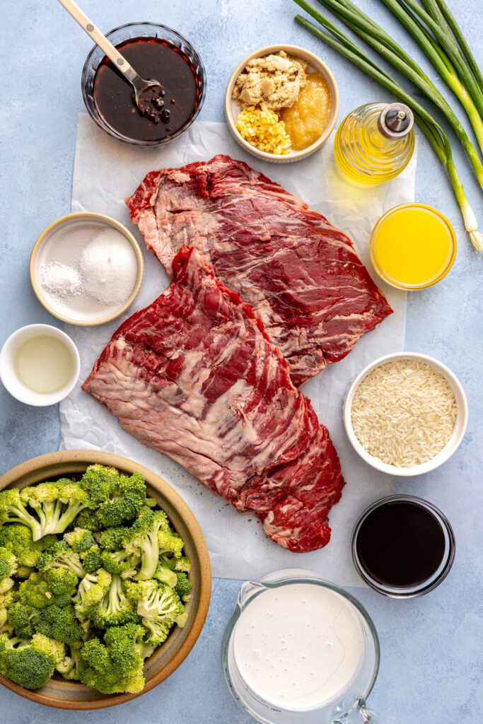 steak and coconut rice ingredients in bowls on a countertop