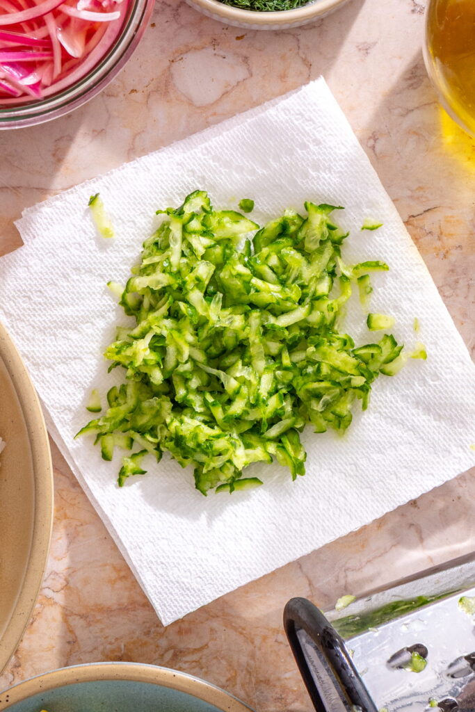 shredded cucumber on a paper towel