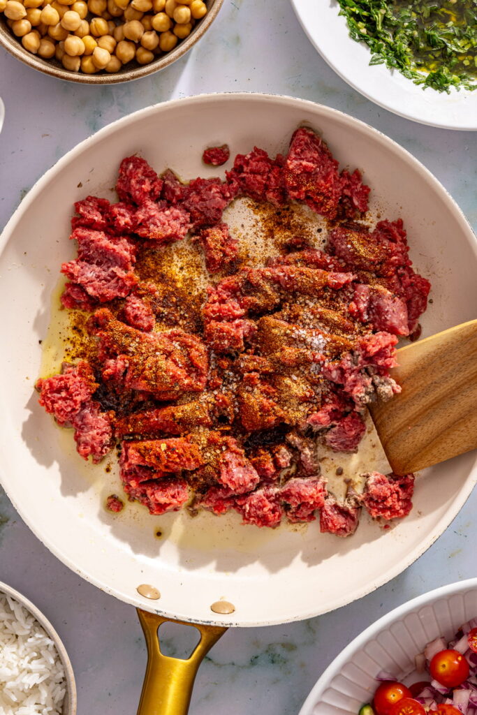 cooking ground beef and spice in a skillet