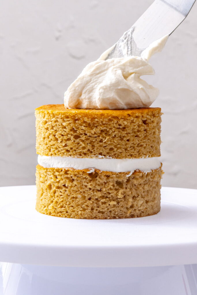frosting a vanilla smash cake